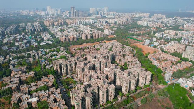 aerial drone shot slow pan of houses, homes, skyscrapers multi story apartments offices in delhi gurgaon showing the densely populated city