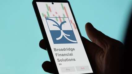 April 09th 2024 , Lake Success, New York. Close up on logo of Broadridge Financial Solutions on the screen of an exchange. Broadridge Financial Solutions price stocks, $BR on a device.