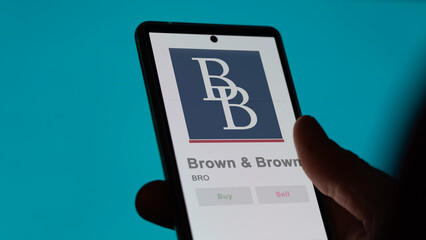 April 09th 2024 , Daytona Beach, Florida. Close up on logo of Brown & Brown on the screen of an exchange. Brown & Brown price stocks, $BRO on a device.