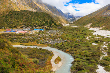View to the settlement of Khambachen (aka Khangpachen or Kambachen) from a hill in the Kanchenjunga region in the Himalaya, Nepal on Kanchenjunga Base Camp trek and Great Himalaya Trail (GHT) - 783681111