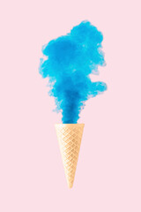 Ice cream cornet with blue smoke on bright pink background. Food concept.