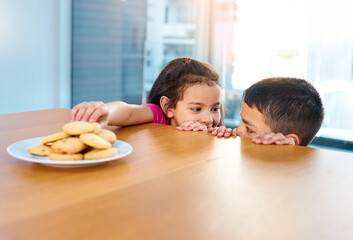 Home, girl and boy in kitchen, cookies and siblings together, brother and sister in morning or...