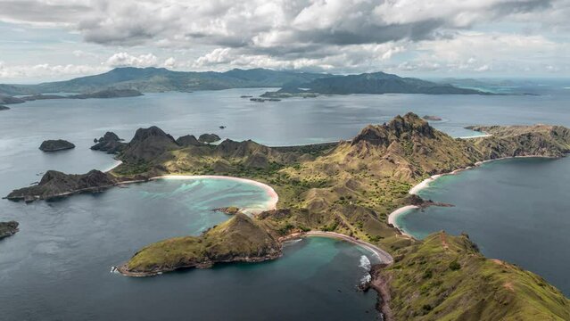 Aerial time lapse of clouds passing over Padar island with beautiful pink beaches and bays in Komodo national park, Indonesia