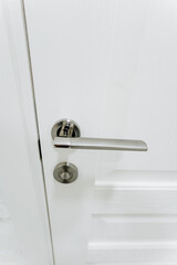 Cupronickel door handle, white door to the room with locking mechanism.
