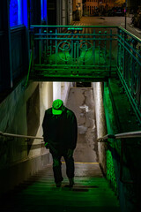 Vienna, Austria A man walks up a green and blue illuminated passage with steps in the innere stadt...