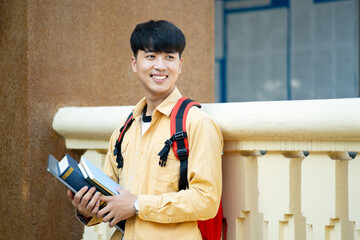 Smiling College Student with Laptop and Books on Campus