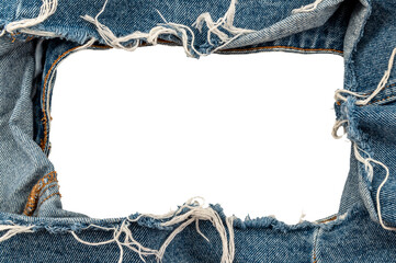 Hole in denim on a white background. Ripped jeans