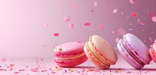 Foto auf Leinwand French macaron biscuit assortment on pastel pink background. minimalist colorful concept of macaroon sandwich cookie from France with copy space, lying in row © igorfrost