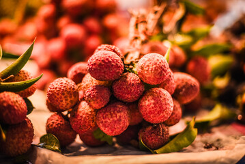 Lychees tied with rubber bands into bunches are sold at fruit markets in Thailand.