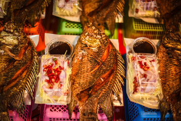 Fried tilapia with dipping sauce is sold in many fresh markets in Thailand.