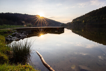 Lake in sunset. Beautiful landscape. Located in the middle of the forest and surrounded by nature, the reservoir offers a great atmosphere. Marbachstausee, Odenwald, Hesse, Germany