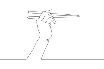 The hand holds chopsticks. Asian traditional cutlery.One continuous line drawing. Line Art isolated...