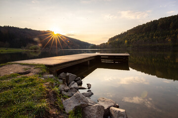 Lake in sunset. Beautiful landscape. Located in the middle of the forest and surrounded by nature, the reservoir offers a great atmosphere. Marbachstausee, Odenwald, Hesse, Germany - obrazy, fototapety, plakaty