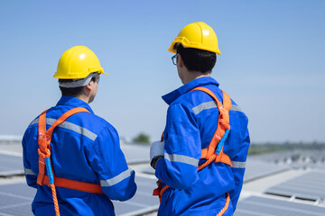 Caucasian engineer checking on solar panel on the rooftop