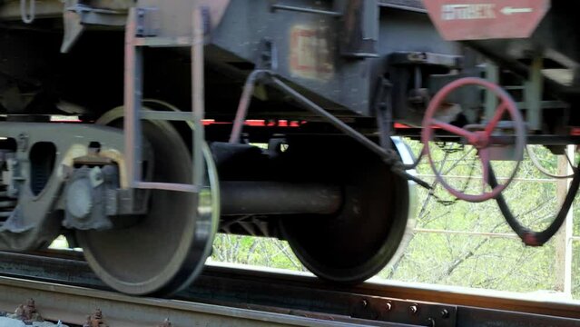 the wheels of a freight train ride on rails 4k video