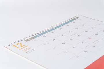 December calendar of 2024 displaying on white background. Desk calendar side view and selective focus shot for concept. 