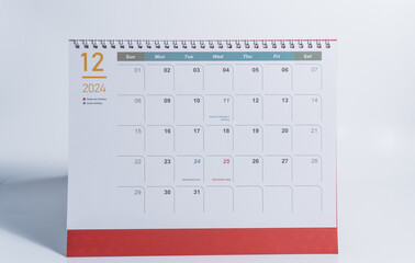 December calendar of 2024 displaying on white background. Desk calendar side view and selective focus shot for concept. 