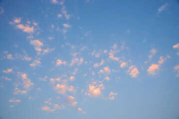fluffy cumulus clouds under a clear blue sky. 