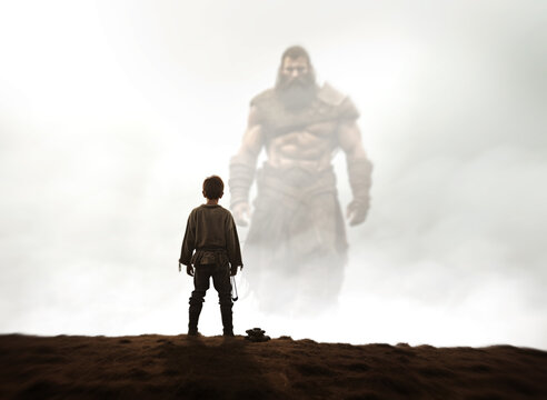 David and Goliath. Bible story of young Shepherd boy defeating a giant Warrior with a small pebble and slingshot. Facing your fears concept. David rear view face off Goliath in the misty background. 