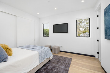 a large bed sitting on top of a wooden floor in a bedroom