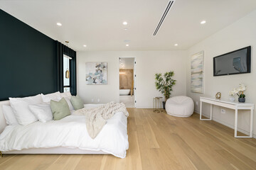 Fototapeta na wymiar this modern white and wood bedroom has black walls and wooden flooring