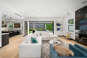 an open living room with white furniture and a fireplace place