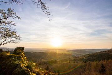 Panorama of a Romanesque landscape at sunset in the evening light. beautiful spring landscape in the mountains. Grass field and rolling hills. View from a rock to the horizon