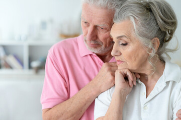 Obraz na płótnie Canvas Close-up portrait of sad senior couple posing
