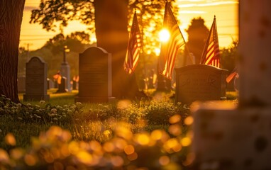 American flags bask in the warm rays of the setting sun, casting a somber yet inspiring glow over a military cemetery at dusk.