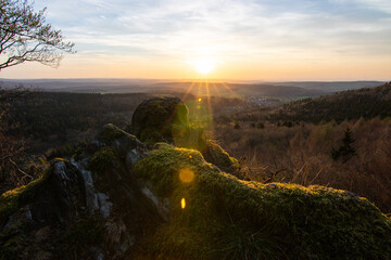 Panorama of a Romanesque landscape at sunset in the evening light. beautiful spring landscape in the mountains. Grass field and rolling hills. View from a rock to the horizon - obrazy, fototapety, plakaty