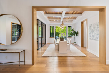 the entry hall is lined with beautiful hardwood flooring and bright lighting