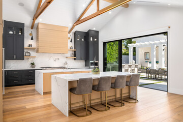 a large open kitchen with black and white countertops and white island
