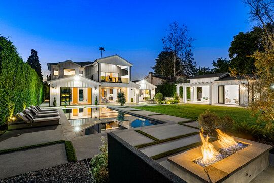 an outdoor living area with an open fire pit and a swimming pool