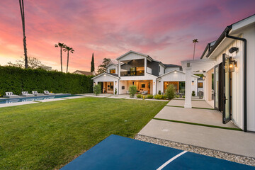 this basketball court has a house on it and it's patio with tennis table - Powered by Adobe
