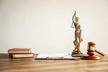 A brown wooden desk in a courtroom symbolizes authority and legal proceedings. It serves as a...