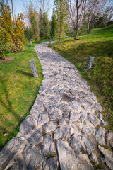 Path made of stones in the garden. Stone path for walking in the park.