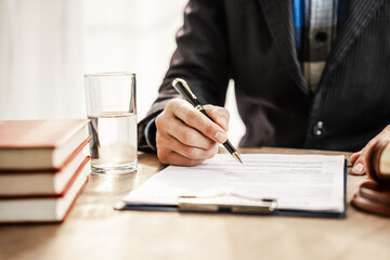 Lawyers meticulously read and check contracts, ensuring legal compliance and protecting clients...