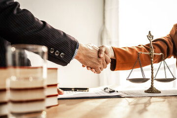 Shaking hands signifies mutual agreement and professionalism. It embodies the essence of justice, with lawyers, judges, and authorities collaborating within the framework of law and judgment. - obrazy, fototapety, plakaty