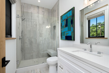 the modern bathroom features large, white counter tops and glass doors