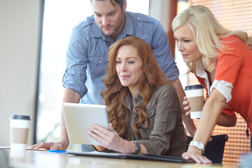 Group of people, colleagues and looking at tablet in room for work, big idea or plan for company. Small business and coworkers with technology for coffee shop, collaboration or teamwork for pitch