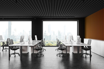 Modern office coworking interior with table and pc monitors, panoramic window