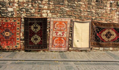 colorful traditional ottoman carpets displayed on the wall