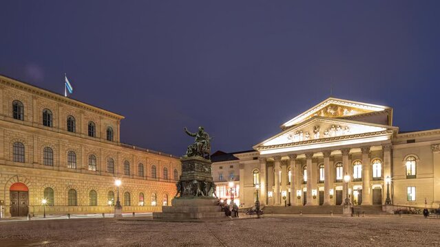 Munich National Theatre or Nationaltheater on the Max Joseph square day to night transition timelapse. Historic opera house, home of the Bavarian State Opera. The statue in the center. Germany
