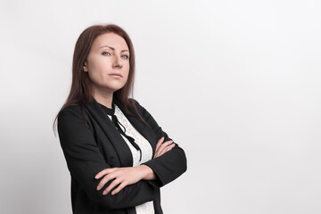 Formal portrait of confident businesswoman employee with arms crossed, looking at camera