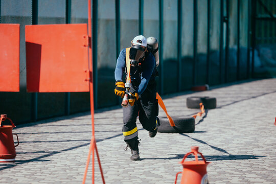 Firefighter training. Firefighters training on the sports ground.