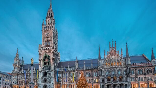 Marienplazt Old Town Square with the New Town Hall timelapse hyperlapse. Neues Rathaus and Town Hall Clock Tower Glockenspiel. Munich skyline, downtown cityscape during sunset. Bavaria, Germany