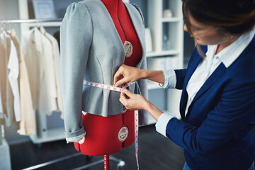 Tailor, fashion and measuring tape on mannequin in boutique workshop with creative seamstress....