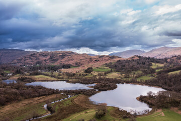 Stunning aerial drone landscape image over River Brathay near Elterwater in Lake District with Langdale Pikes in distance - 783775931