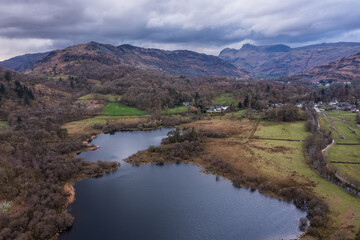Stunning aerial drone landscape image over River Brathay near Elterwater in Lake District with Langdale Pikes in distance