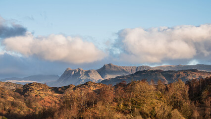 Beautiful Spring landscape image in Lake District looking towards Langdale Pikes during colorful sunset - 783776112